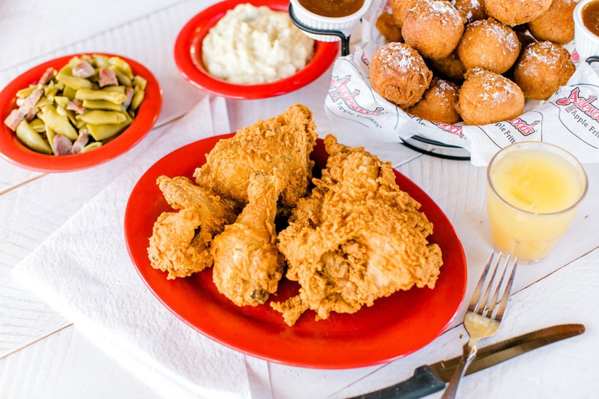 image of fried chicken, green beans, mashed potatoes, and apple fritters from applewood farmhouse restaurant in sevierville tn