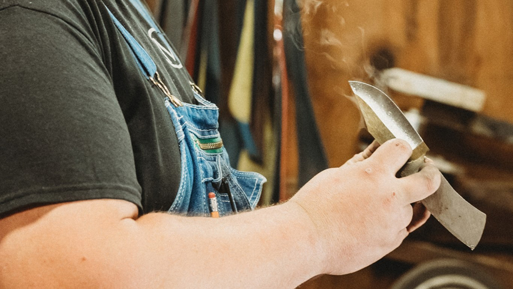 image of a knife maker checking his work at the craftsmen's fair in gatlinburg tn