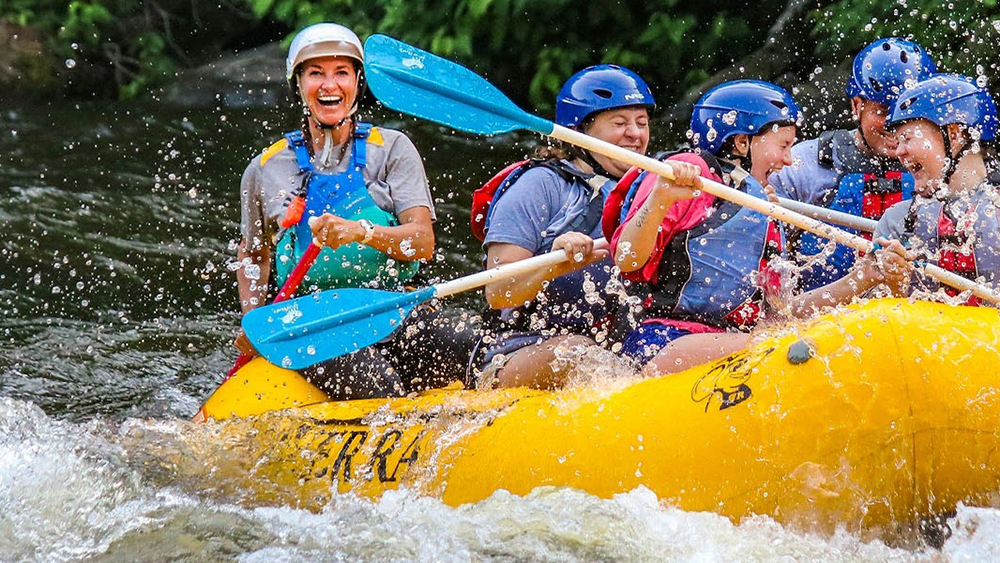 a group white water rafting with river rat in the smoky mountains