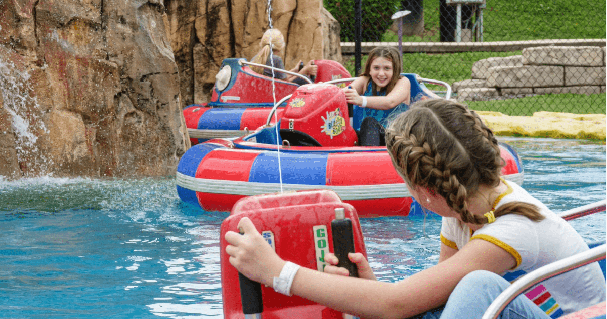 A fun action shot of guests enjoying the bumper boats on a sunny day