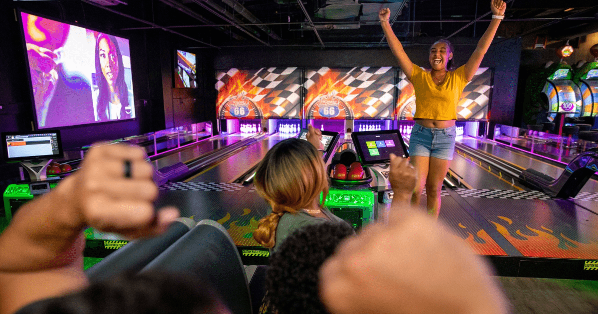 Players enjoying a round of mini bowling indoors via NASCAR SpeedPark site