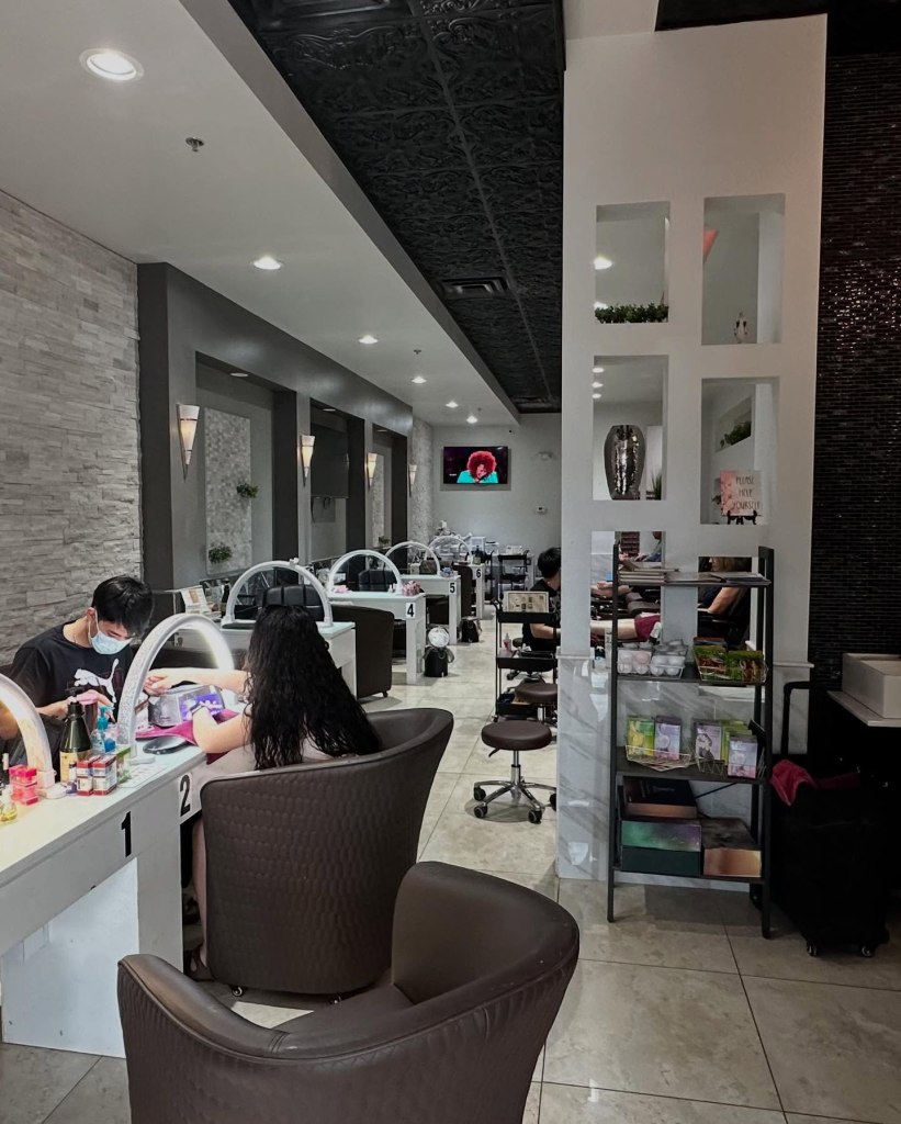 Another view of the Noire Nail Bar interior's other side full of manicure stations.