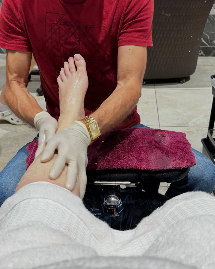Female patron receiving a leg massage as part of the Deluxe Pedicure at Noire Nail Bar in Sevierville, TN.