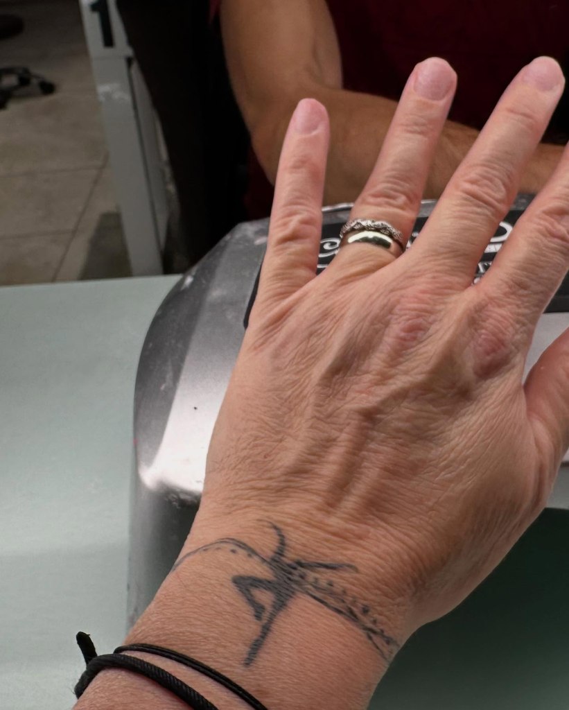 Before image of a female patron's hand before manicure service at Noire Nail Bar.