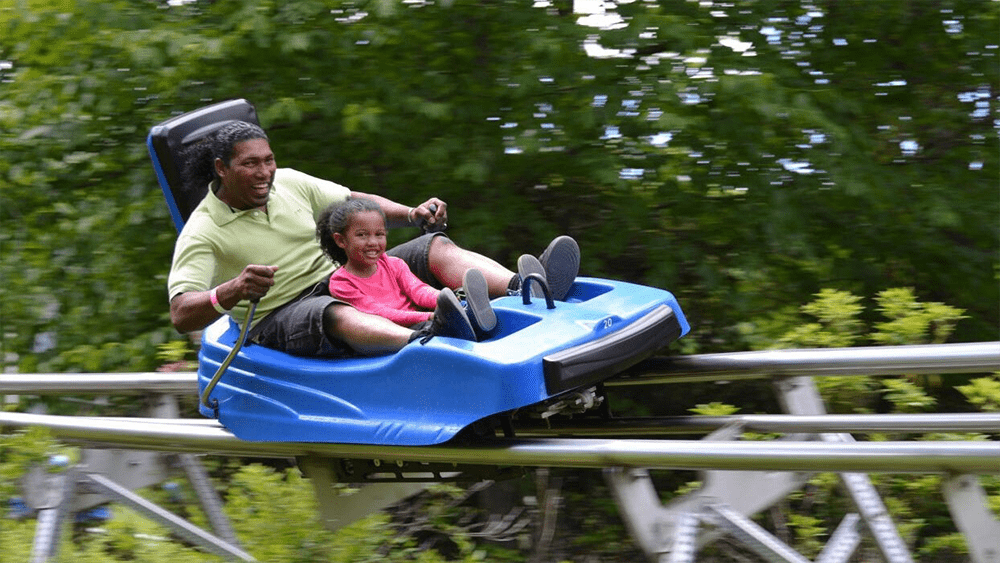 Father and daughter riding Ober Mountain's Tennessee Flyer Mountain Coaster via website Father and daughter riding Ober Mountain's Tennessee Flyer Mountain Coaster via website