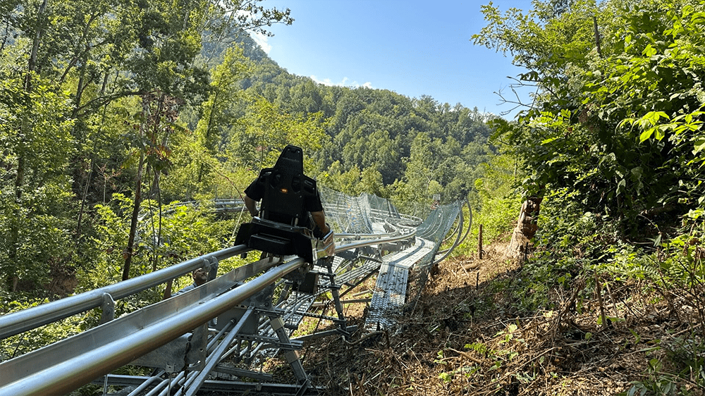 Tourist riding Anakeesta's Hellbender Mountain Coaster in Gatlinburg TN via website Tourist riding Anakeesta's Hellbender Mountain Coaster in Gatlinburg TN via website