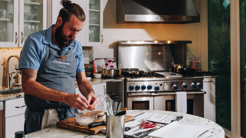 Private chef from CookinGenie preparing a meal for guests.
