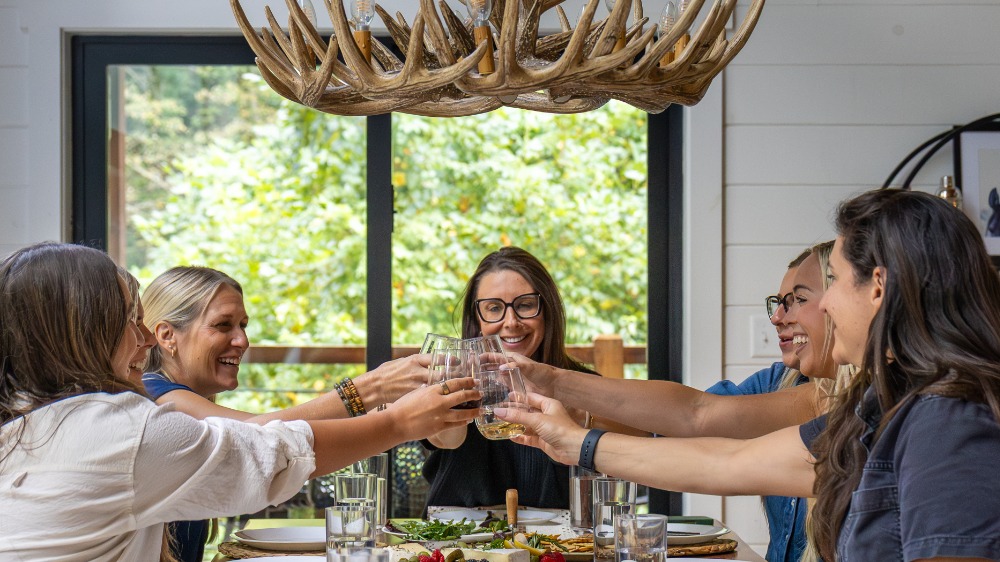 Group of women celebrating with CookinGenie meal.