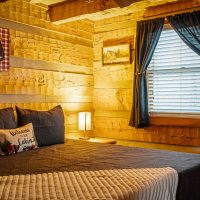 Bedroom one with bedside lamp on at Hapey Memories