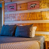 View of bedroom one with bedside lamp at Hapey Memories