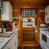 View of galley kitchen and front door at Hapey Memories