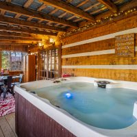 View of hot tub and game table at Hapey Memories