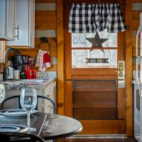 View of kitchen and front door from breakfast nook at Hapey Memories