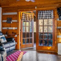 View of open back porch door from living room at Hapey Memories