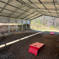 sleepy bear ranch covered back yard and cornhole