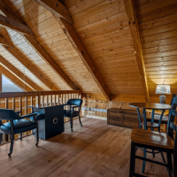 Little Bear loft area with arcade table and seating