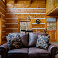 View of couch and dining area at Little Bear cabin