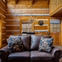 View of couch and dining area at Little Bear cabin