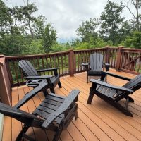 Enclosed deck with mountain view at sunny view cabin.