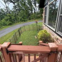 Side yard with fenced dog area at sunny view cabin.