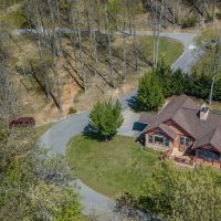 Aerial drone view of Sunny View Cabin and steep driveway approach in Shagbark gated community Sevierville Tennessee