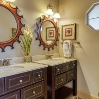 Bathroom vanity with oval mirror and warm lighting at Sunny View Cabin pet-friendly cabin rental in Sevierville Tennessee