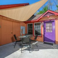 Side exterior view of Sunny View Cabin showing detached garage and outdoor patio area in Shagbark community Sevierville TN