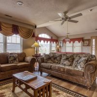 Bright living area with natural light, ceiling fan, and comfortable furnishings at Sunny View Cabin Sevierville Tennessee