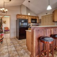 Open galley-style kitchen with bar seating at Sunny View Cabin in Sevierville TN