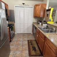 View of galley style kitchen at sunny view cabin.