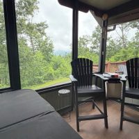View of mountains from hot tub at sunny view cabin.