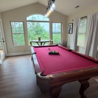 View of pool table and mountain views at sunny view cabin.